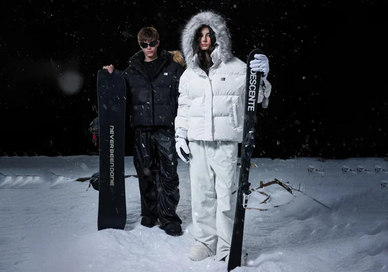 FDR Cyber Y2K fashion unisex style snowwear, models in oversized puffer jackets holding snowboards in snowy night