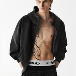 Male model wearing an unzipped black hoodie showing cropped inner styling.
