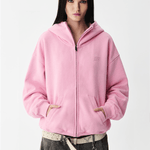 Close-up shot of a female model wearing a pink hoodie with the hood pulled up over the face.