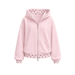 A light pink zip-up hoodie with black polka dots on the hood lining, hem, and cuffs, shown against a plain white background.