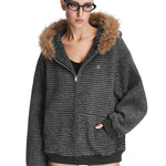 Model wearing dark grey textured zip-up hoodie with brown faux fur trim hood, high-street fashion aesthetic.