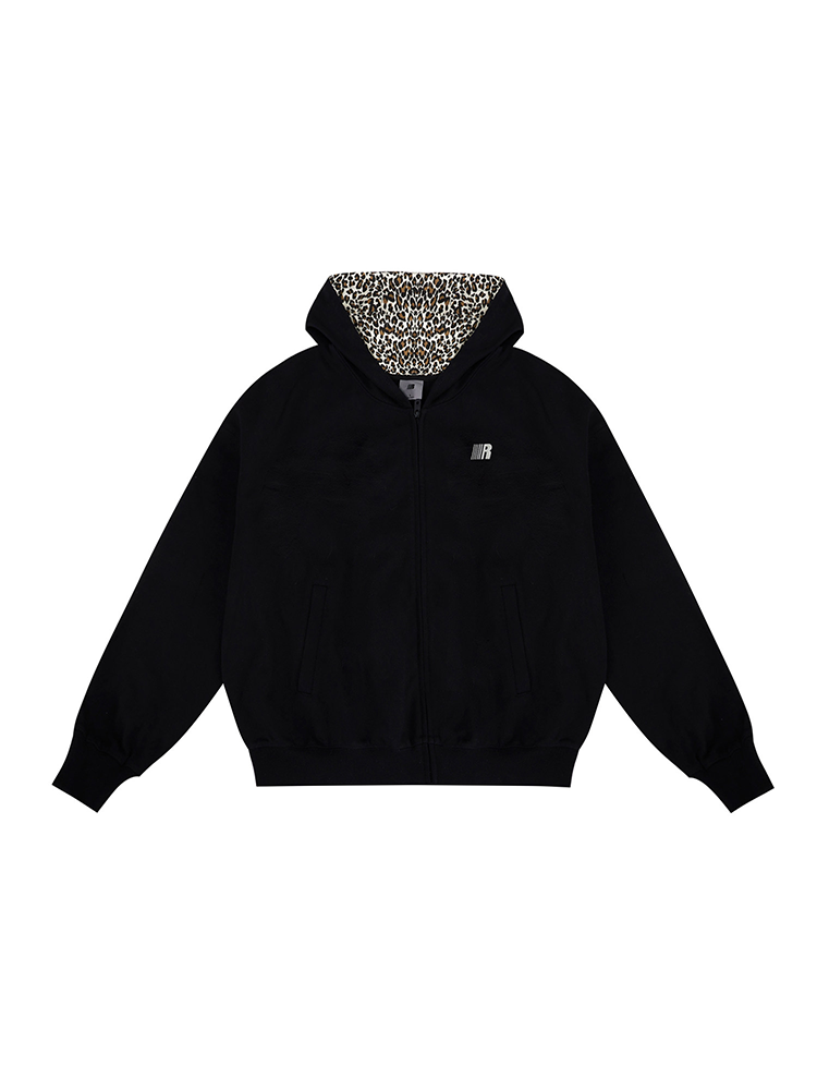 Flat lay of black zip-up hoodie with leopard print lined hood and cat ears on white background.