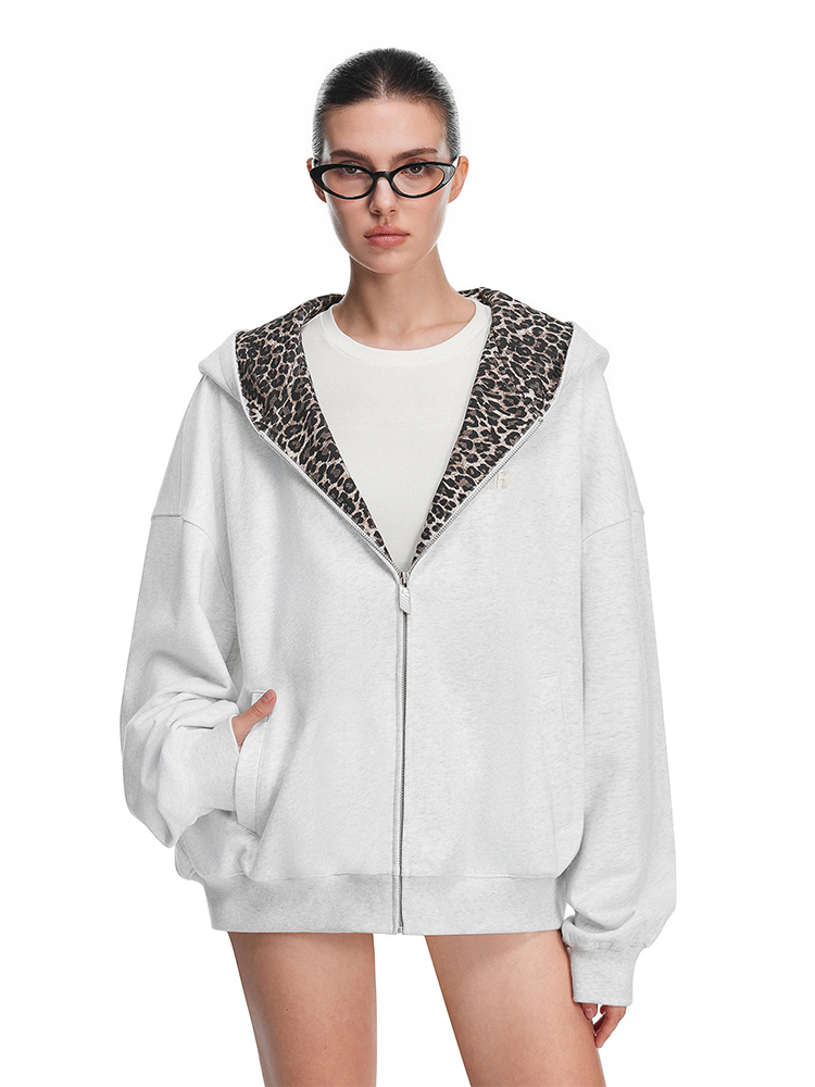 Front view of grey hoodie on model, highlighting cat ears on hood and full-length zipper detail.