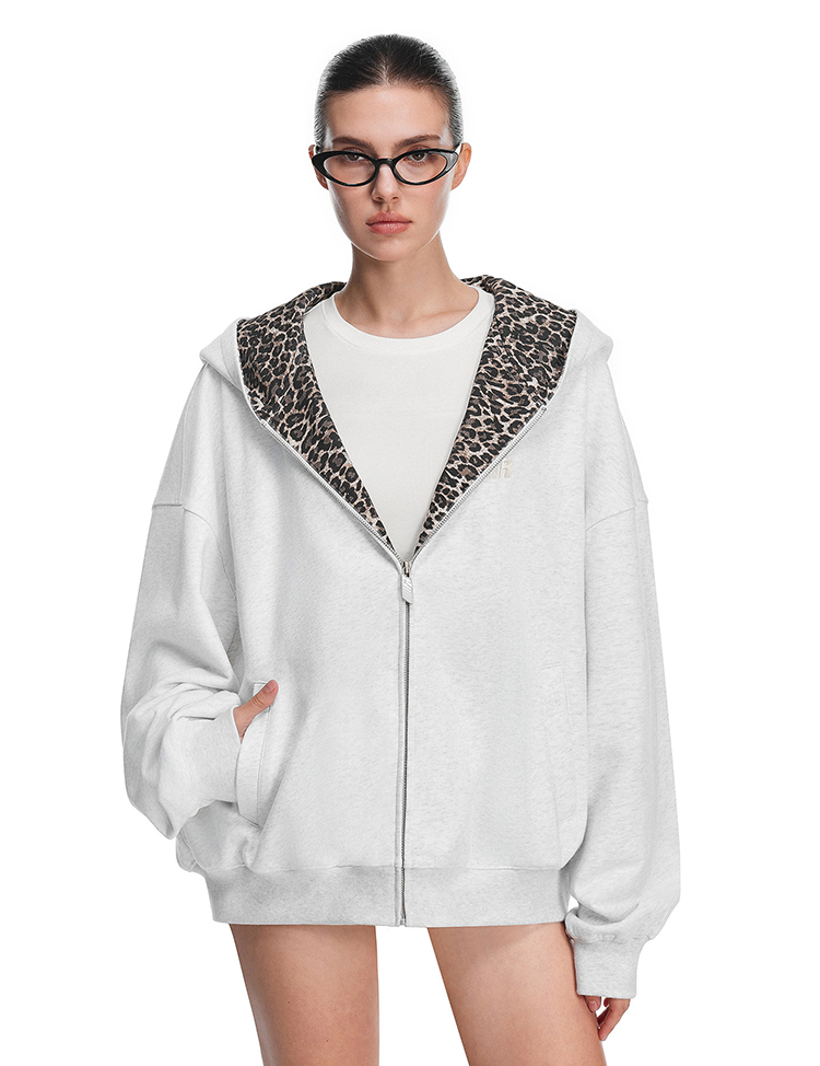 Front view of grey hoodie on model, highlighting cat ears on hood and full-length zipper detail.