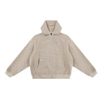 Studio flat lay of the cream textured hoodie, displaying the ribbed technical fabric, full-length zipper, and oversized silhouette.