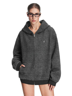 A model showcasing the charcoal black textured zip-up hoodie, featuring a relaxed boxy fit and integrated side pockets.