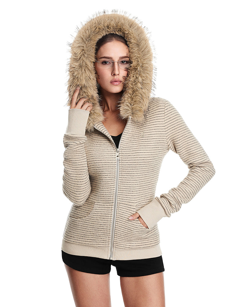 A front view of a model wearing a closed cream-colored ribbed-knit jacket with a large brown faux fur-trimmed hood, showcasing the texture.