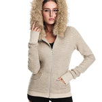 A front view of a model wearing a closed cream-colored ribbed-knit jacket with a large brown faux fur-trimmed hood, showcasing the texture.