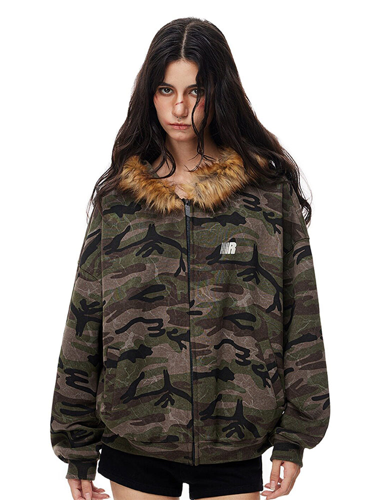 Model wearing dark camo print zip-up jacket with faux fur collar, vintage streetwear aesthetic.