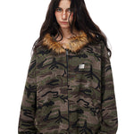 Model wearing dark camo print zip-up jacket with faux fur collar, vintage streetwear aesthetic.