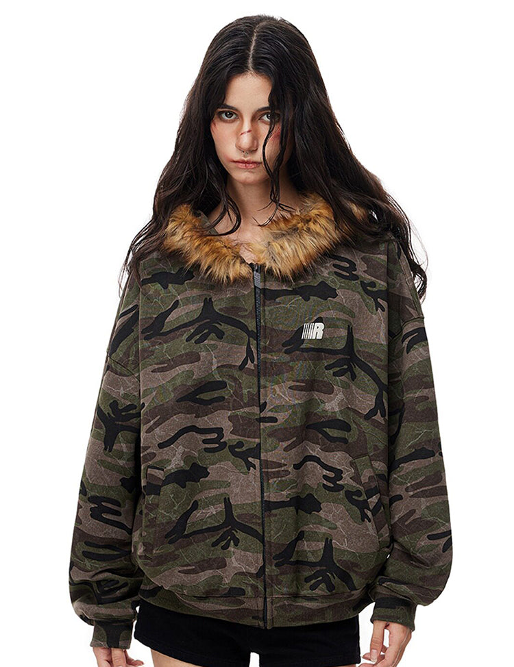 Model wearing dark camo print zip-up jacket with faux fur collar, vintage streetwear aesthetic.