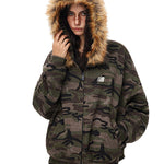 Front view of model in oversized camouflage hoodie with zip closure and small logo patch.