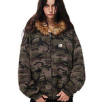Full body shot of model styling camo jacket with black shorts and chunky boots.