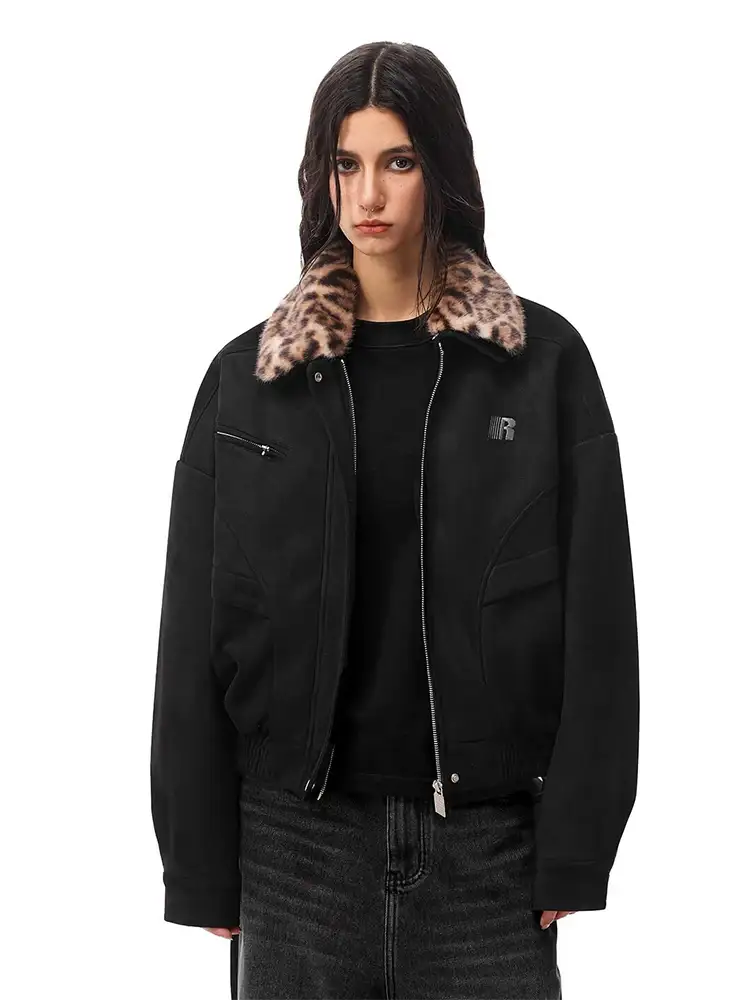 Model wearing black zip-up bomber jacket with leopard print faux fur collar, vintage streetwear style.