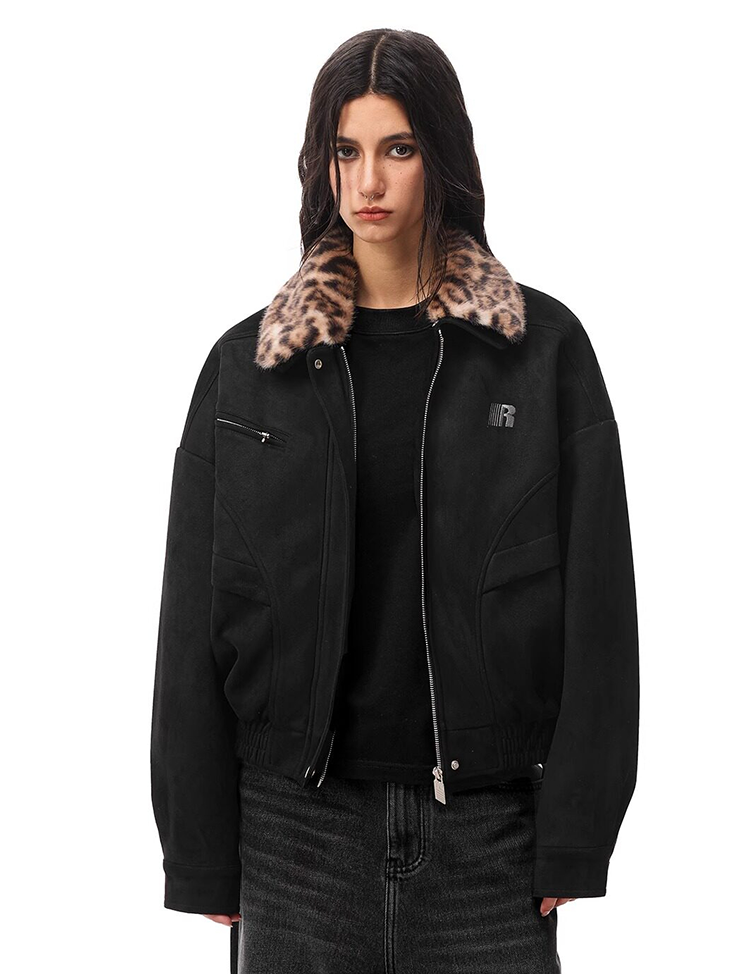 Model wearing black zip-up bomber jacket with leopard print faux fur collar, vintage streetwear style.