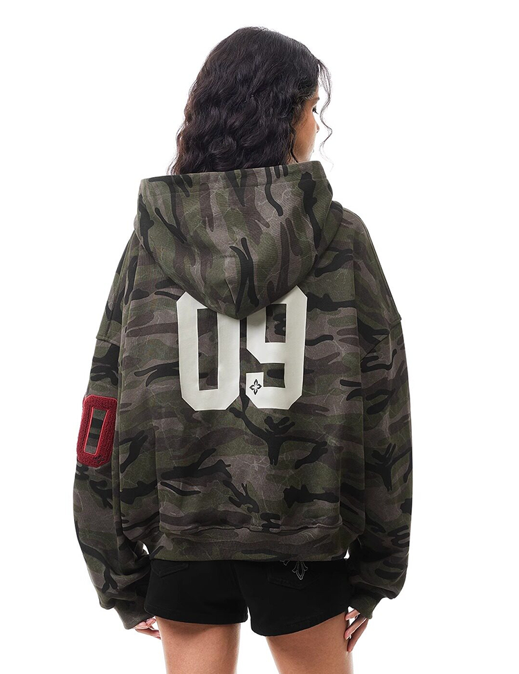 Back view of camouflage hoodie featuring large grey "09" number print on the back, vintage streetwear.
