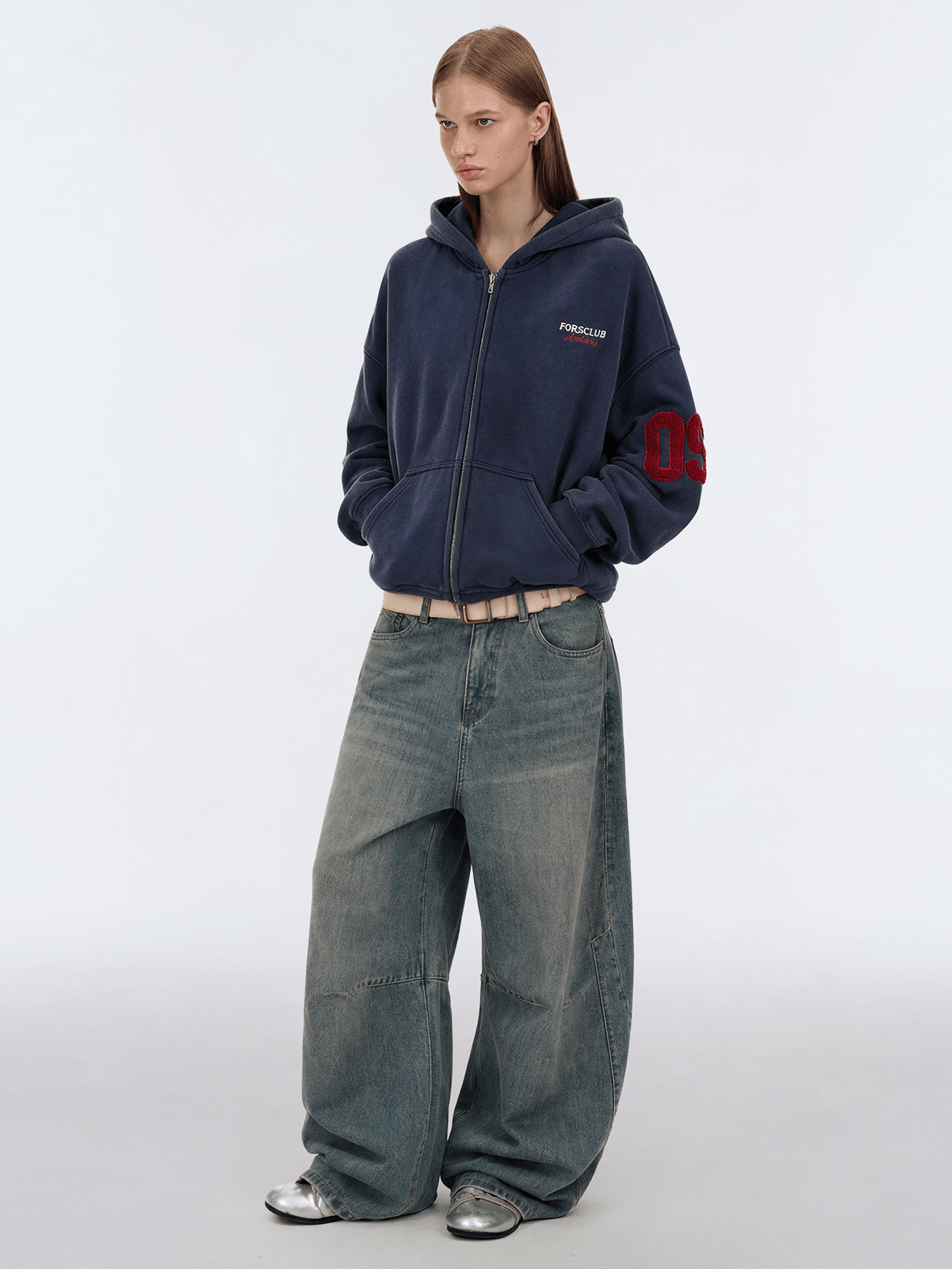 Back view of model wearing Signature Embroidered Zip Hoodie in Navy Blue - FDR