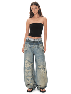Front view of model wearing Vandal Distressed Baggy Jeans in Denim Blue - FDR