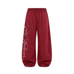 Burgundy red wide-leg baggy sweatpants with drawstring waist, product front view