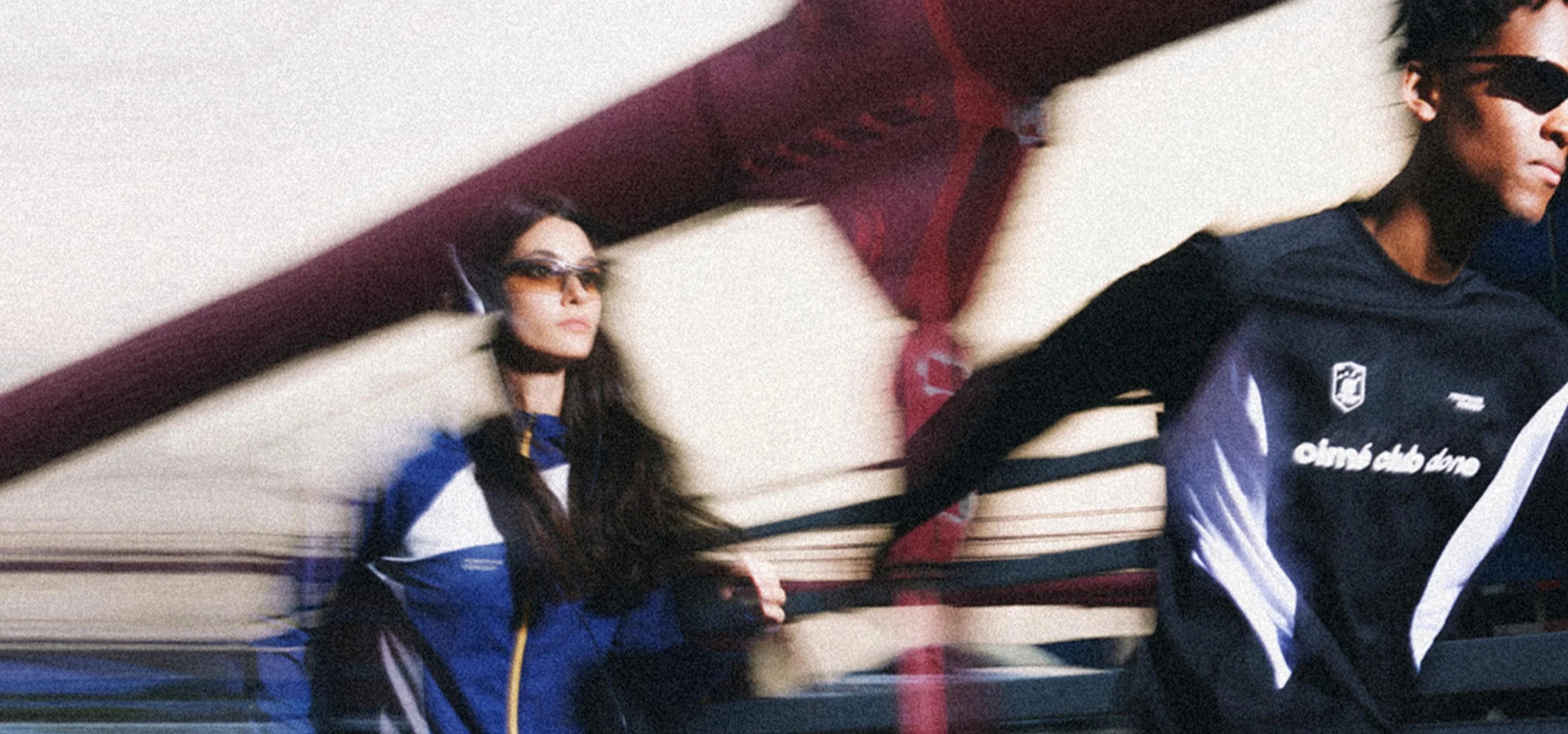 FDR Cyber Y2K fashion, two models in oversized unisex style sport jackets on urban walkway