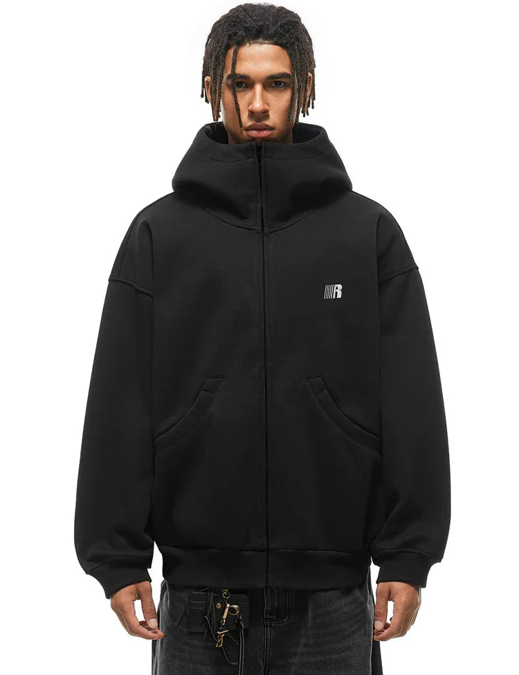 Male model in black oversized high-neck hoodie, showcasing the structured standing collar silhouette.