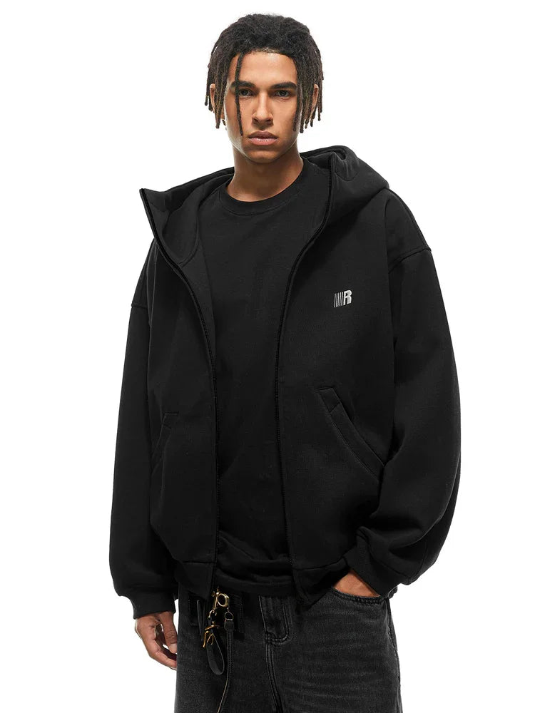 Front view of black zip-up hoodie featuring minimalist chest logo and baggy streetwear fit.