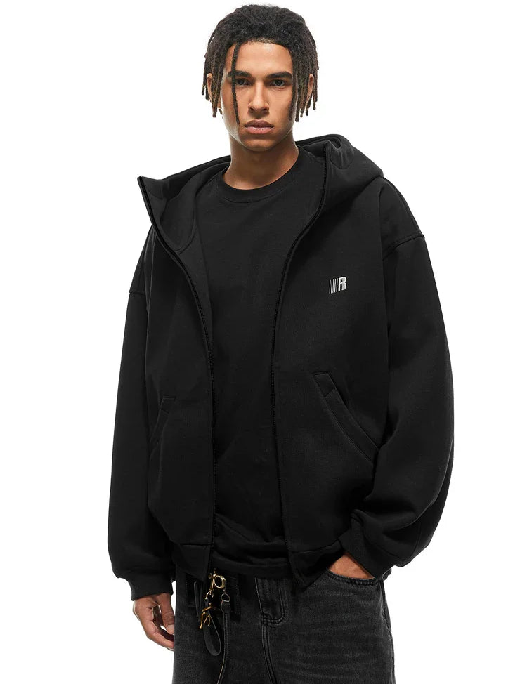 Front view of black zip-up hoodie featuring minimalist chest logo and baggy streetwear fit.