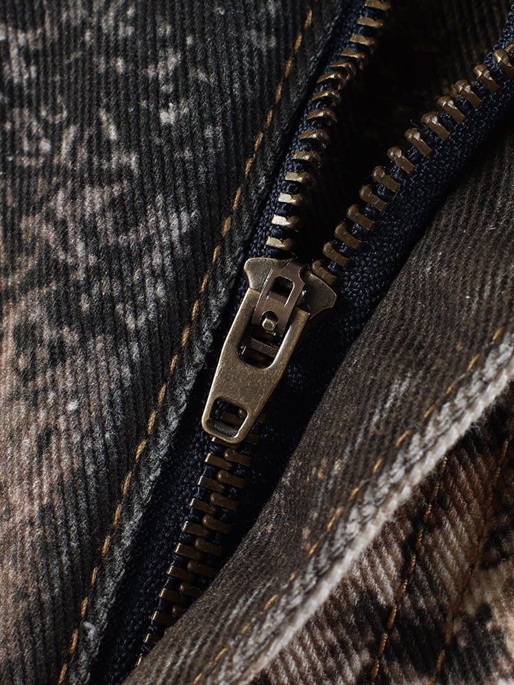 Macro shot of premium metal zipper and heavy washed fabric texture on FDR Studios techwear pants.