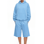 Full-body front view of a model wearing a lake blue hoodie and matching shorts, paired with blue flip-flops.