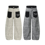 Side-by-side comparison of light khaki and dark grey leopard print wide-leg trousers.