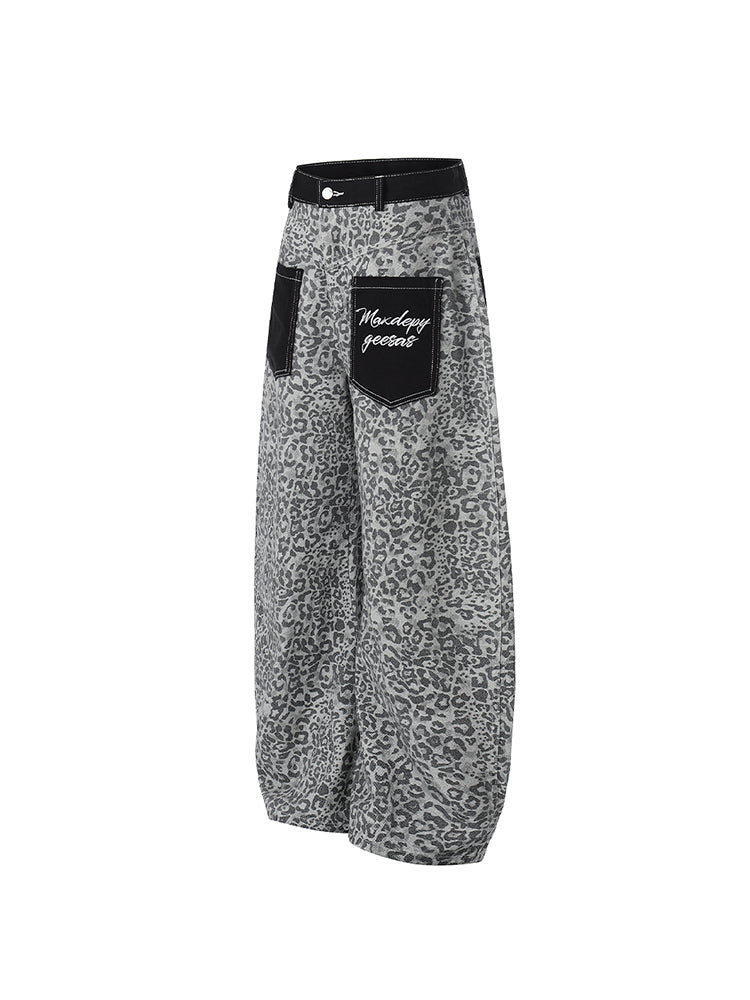 Side profile of the grey leopard print wide-leg pants highlighting the draped silhouette.