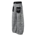Side profile of the grey leopard print wide-leg pants highlighting the draped silhouette.