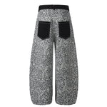 Rear view of grey leopard print streetwear pants with symmetrical black back pockets.