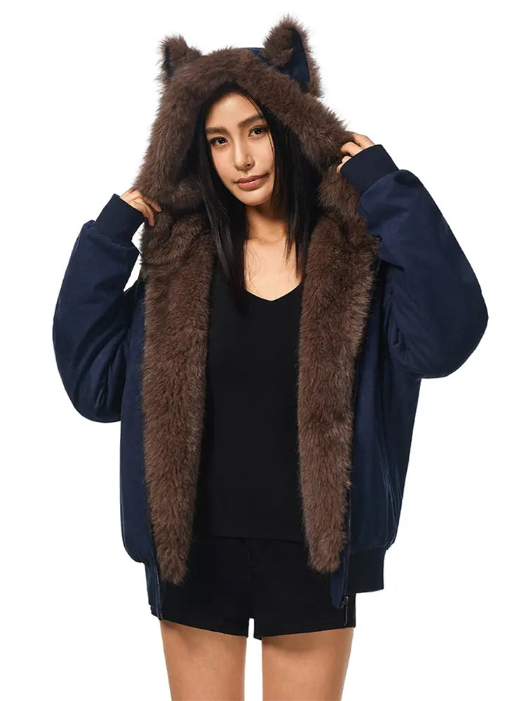 A model wears a dark navy blue women's jacket with a large, fluffy brown faux fur hood and brown cat ears.