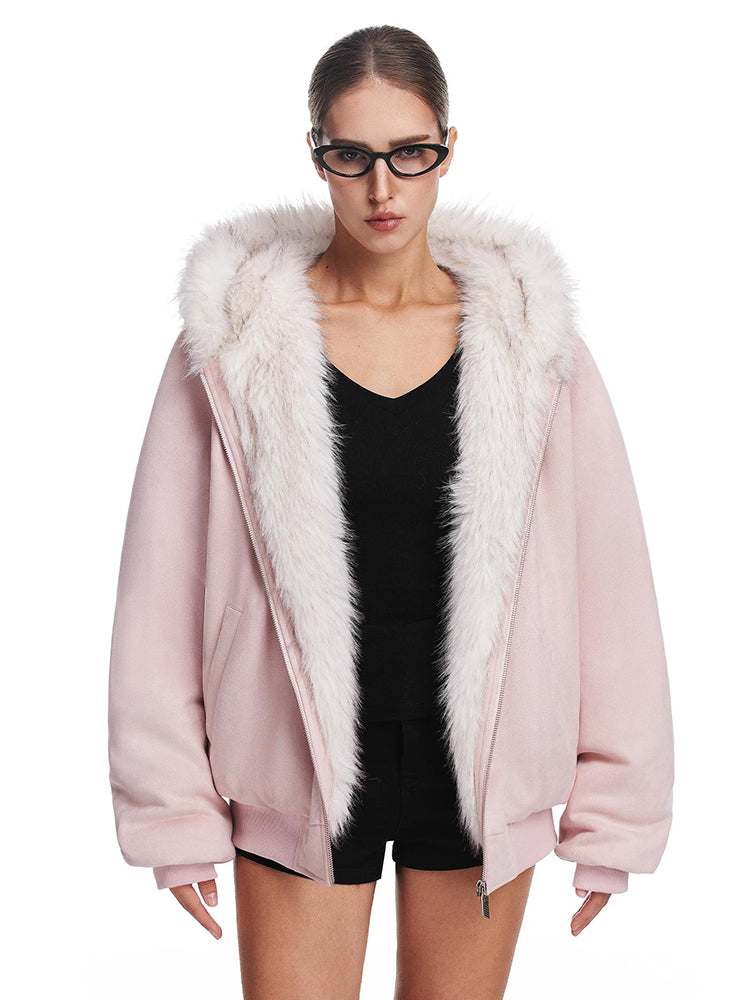 A model poses in a light pink hooded jacket with plush white faux fur trim and cat ears, showing the fluffy details.