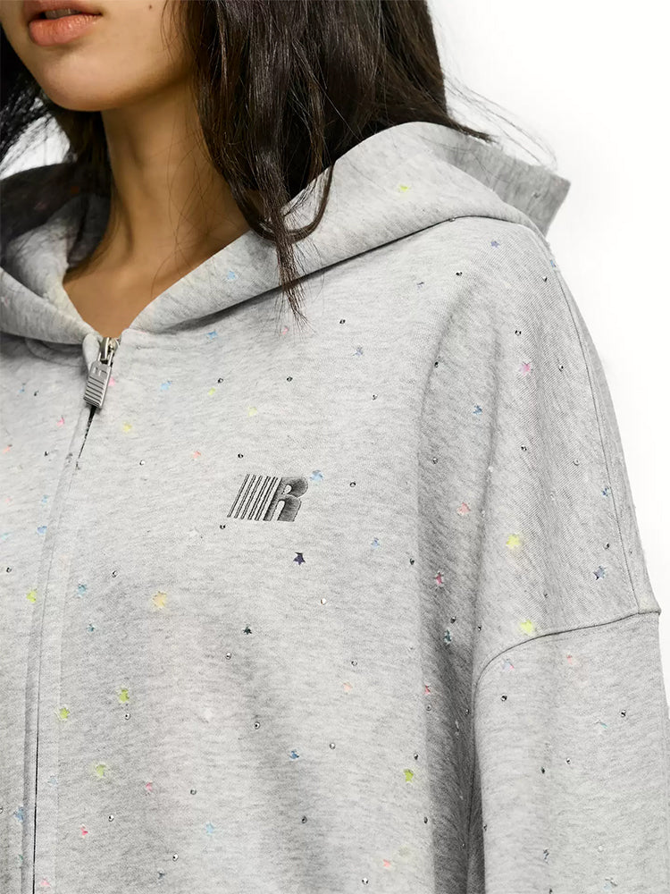 Close up of rhinestone star detail on grey confetti zip up hoodie