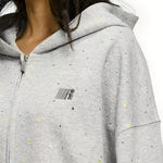 Close up of rhinestone star detail on grey confetti zip up hoodie