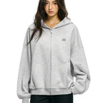 Side profile of baggy grey zip up hoodie showing oversized sleeve silhouette