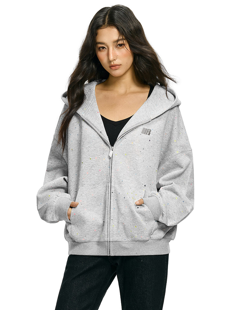 Model wearing oversized rhinestone star hoodie in marled grey streetwear style