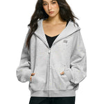 Model wearing oversized rhinestone star hoodie in marled grey streetwear style