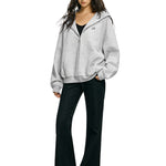 Model wearing oversized rhinestone star hoodie in marled grey streetwear style