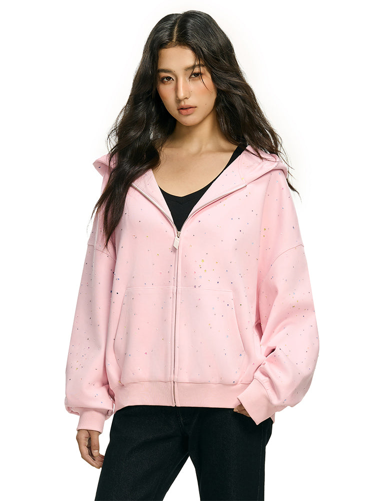 Model wearing pink rhinestone star hoodie in high street streetwear aesthetic