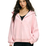 Model wearing pink rhinestone star hoodie in high street streetwear aesthetic