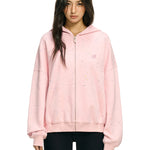 Front portrait of baggy pink confetti hoodie with signature star detailing