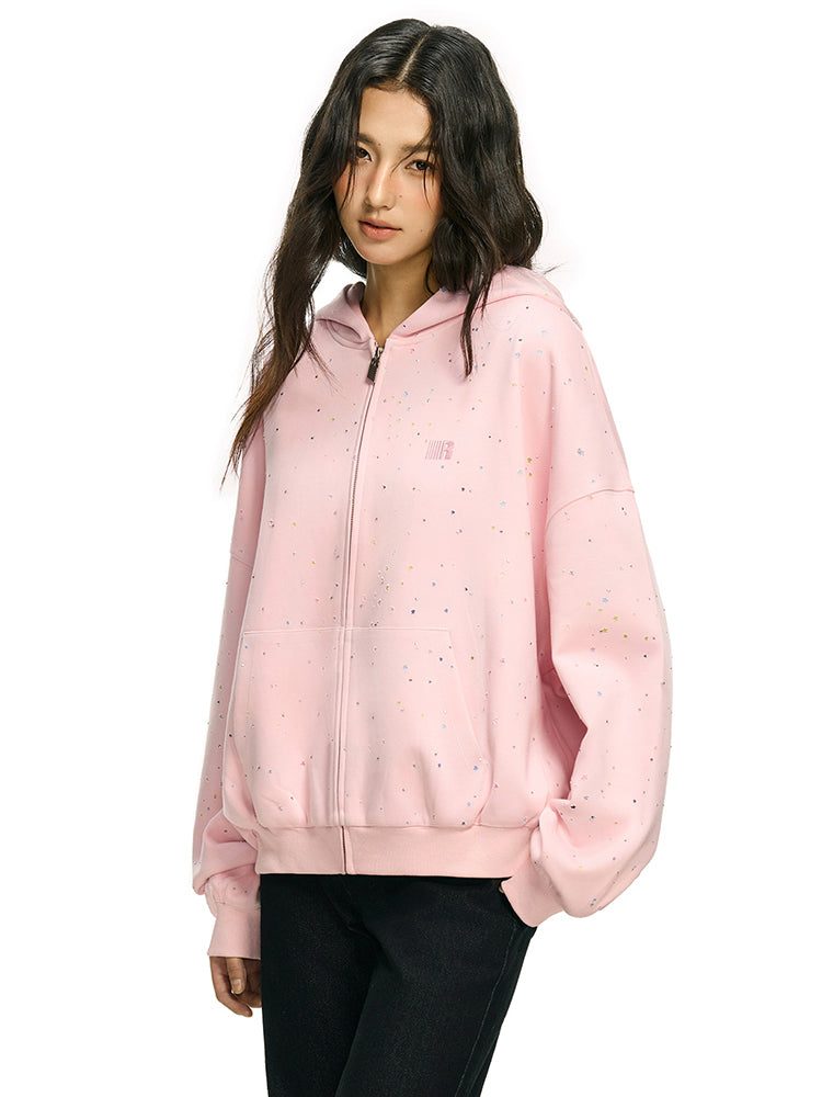 Three-quarter view of pink oversized hoodie showing slouchy sleeve silhouette