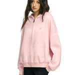Three-quarter view of pink oversized hoodie showing slouchy sleeve silhouette