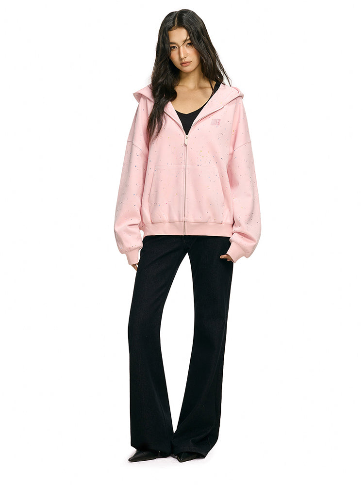 Full length shot of model in pink oversized hoodie and flared black trousers