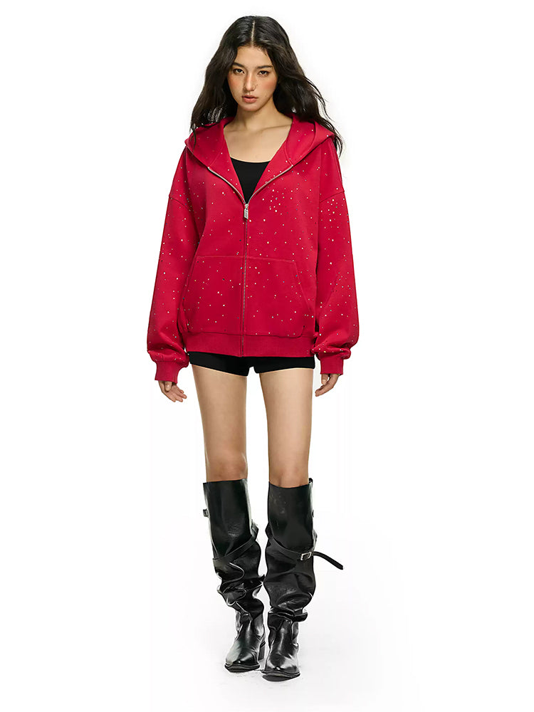 Full body shot of model wearing red rhinestone star oversized hoodie with black boots