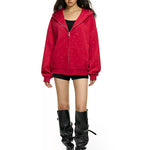 Full body shot of model wearing red rhinestone star oversized hoodie with black boots
