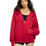Front view of baggy red zip up hoodie with kanga pockets and rhinestone stars